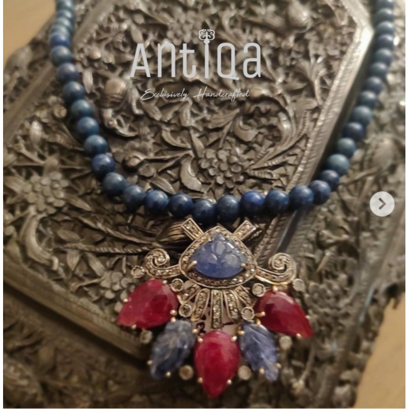 Handcrafted Pendant Studded With Carved Blue Sapphire, Rubies And Melle Diamonds